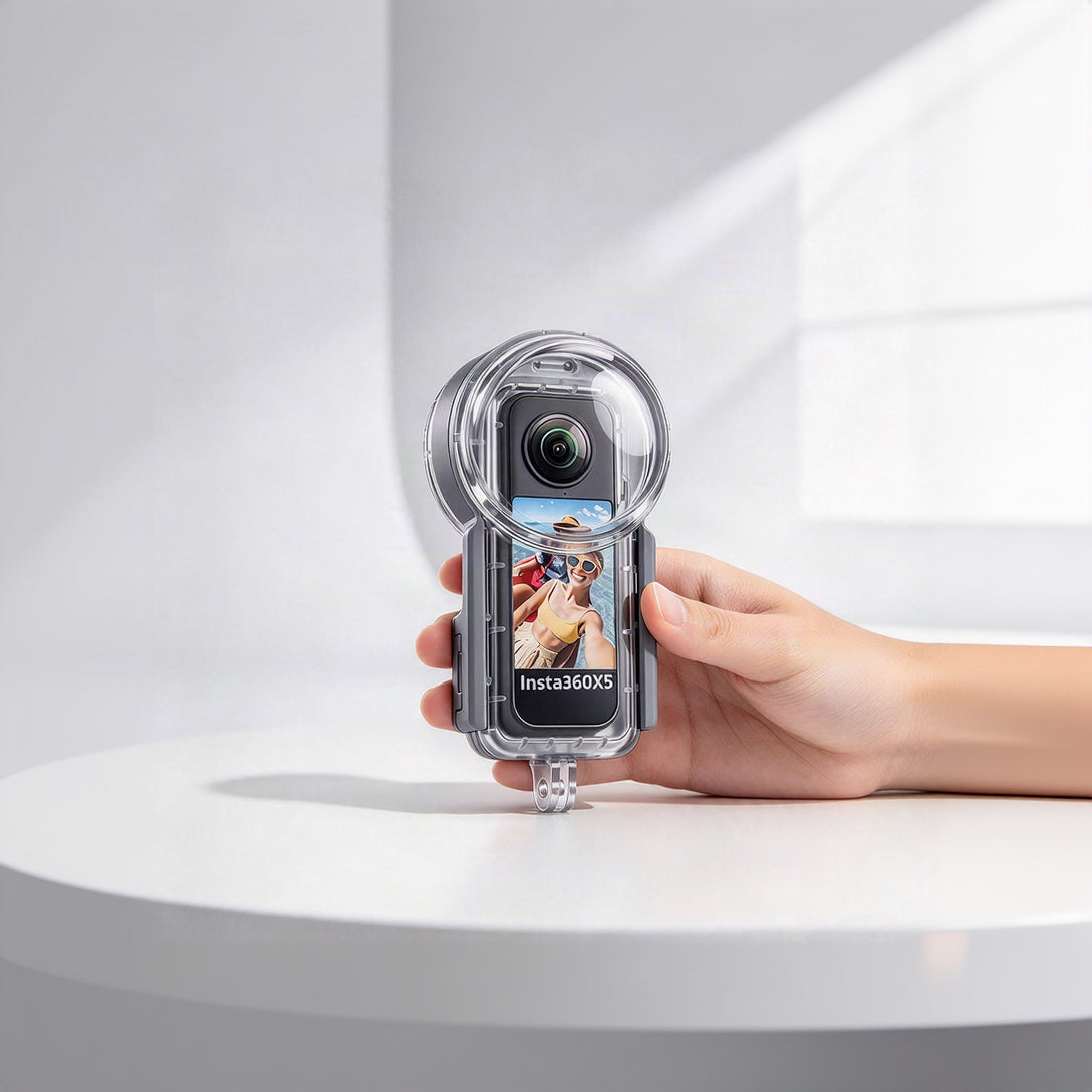 A hand holding a clear waterproof housing case around an Insta360X5 action camera, shown against a bright white background with soft window shadows.